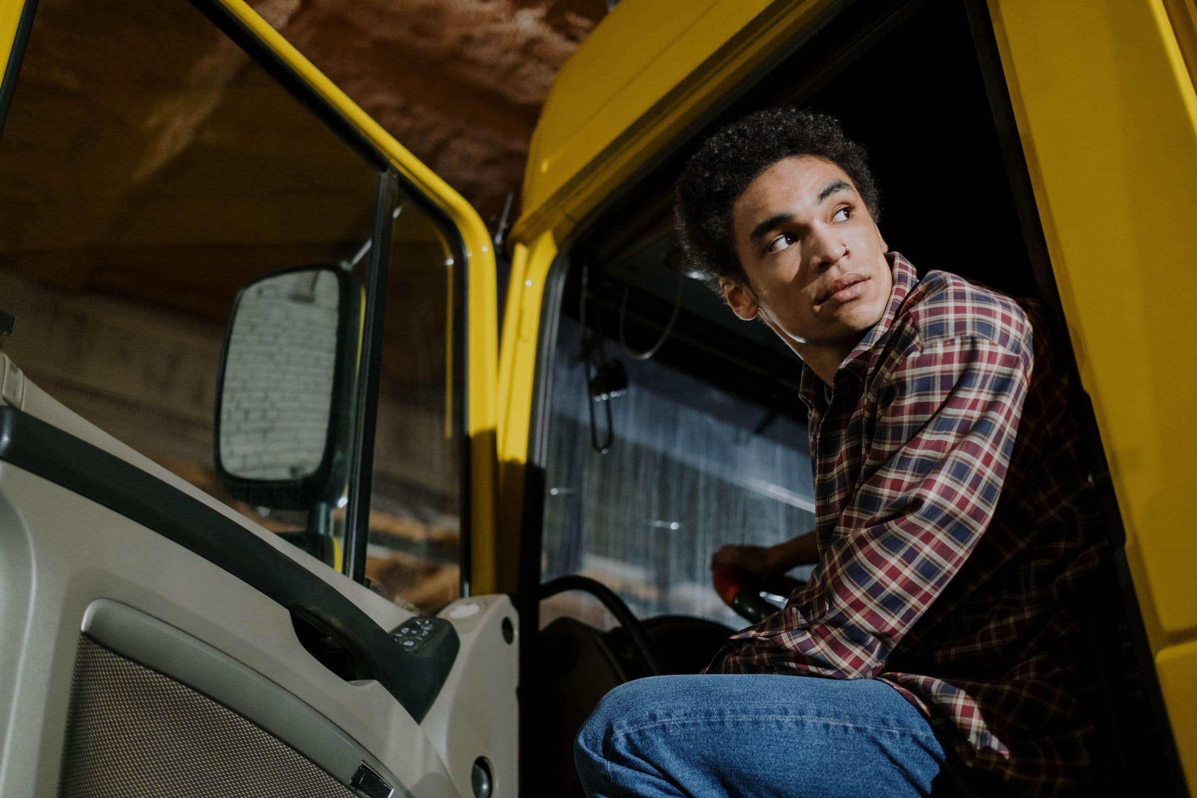 Student driver training beside a company tractor with an instructor