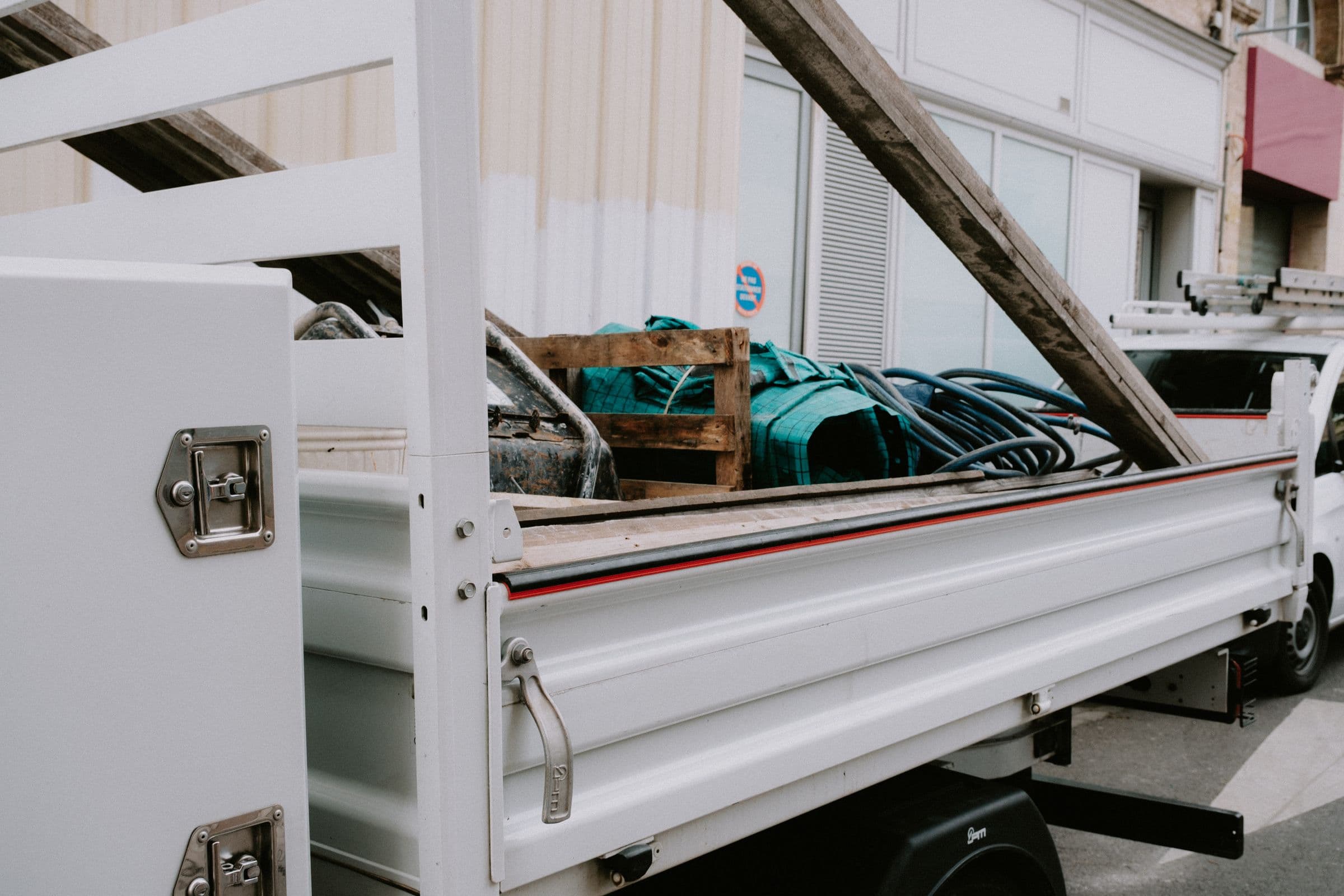 Flatbed trailer loaded with steel and secured with chains and straps
